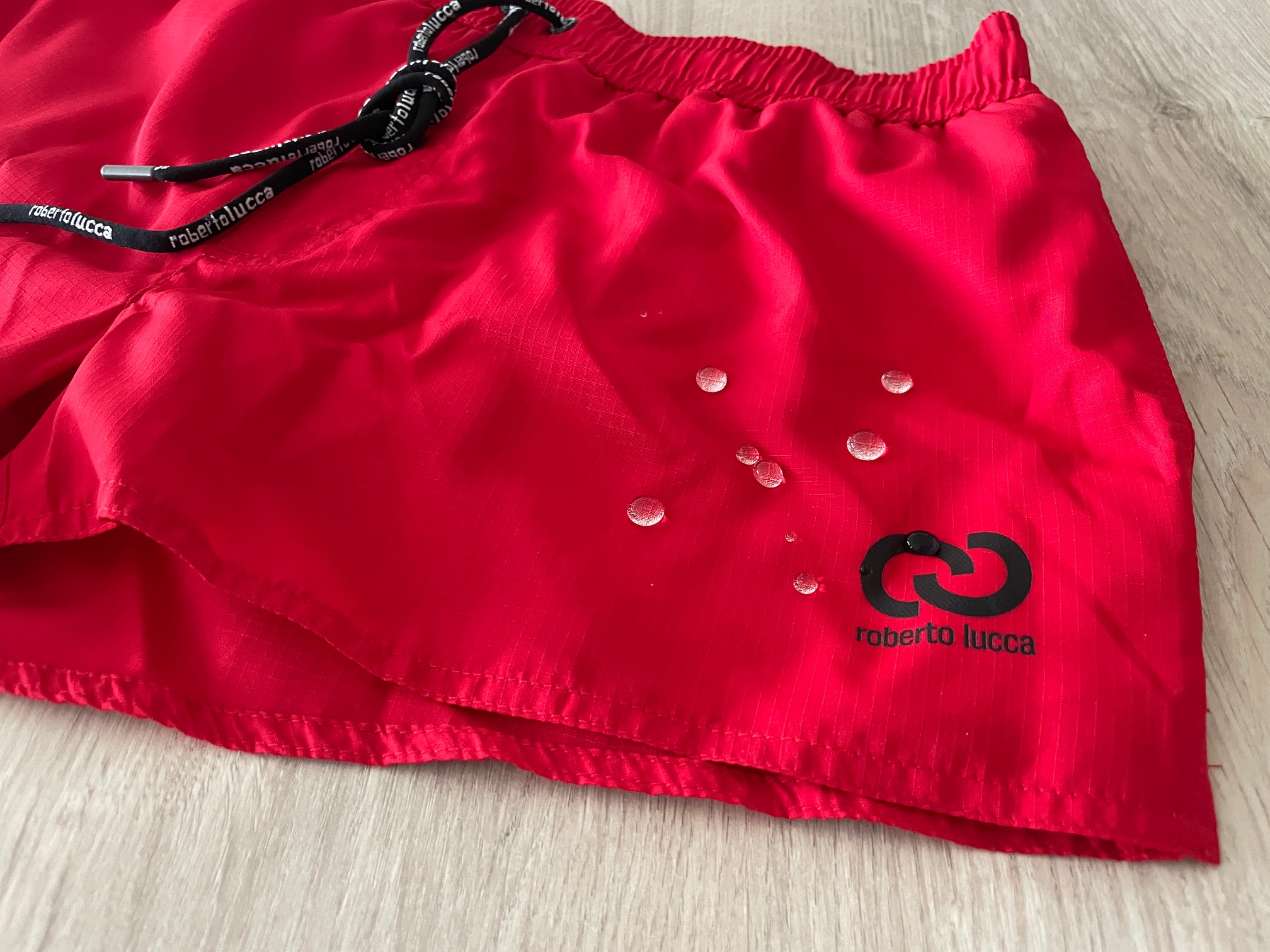 Close-up of Roberto Lucca swimwear Hi-Tech fabric — material structure designed for rapid moisture transport