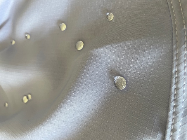 Close-up of Hi-Tech fabric in Roberto Lucca men”s swimwear — water-repellent surface, water drops